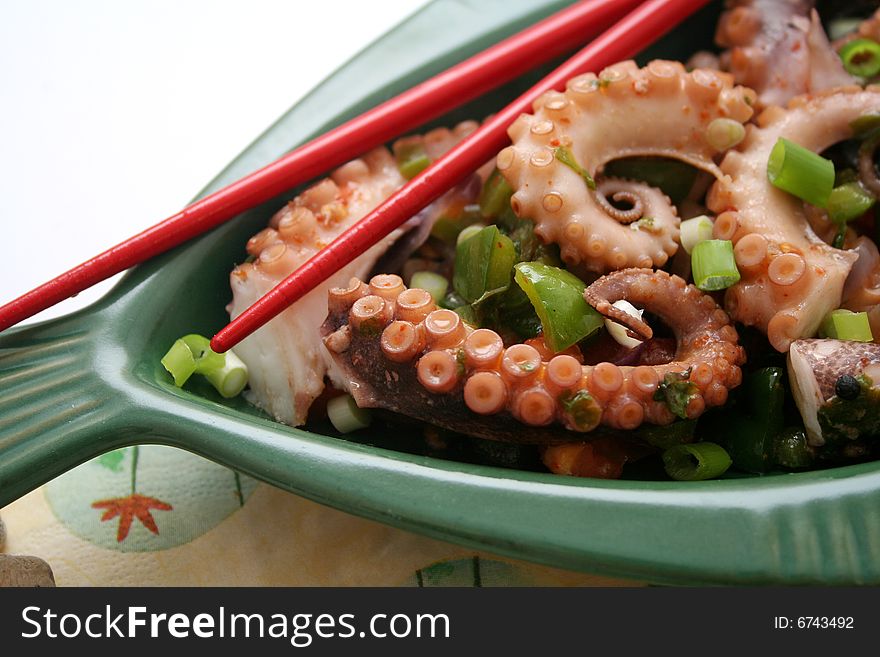 A grilled octopus with different kind of vegetables