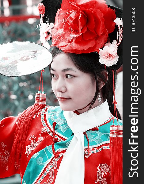 Portrait of a beautiful girl in Chinese ancient dress. 
Chinese on the fan is meant and missed. Portrait of a beautiful girl in Chinese ancient dress. 
Chinese on the fan is meant and missed.