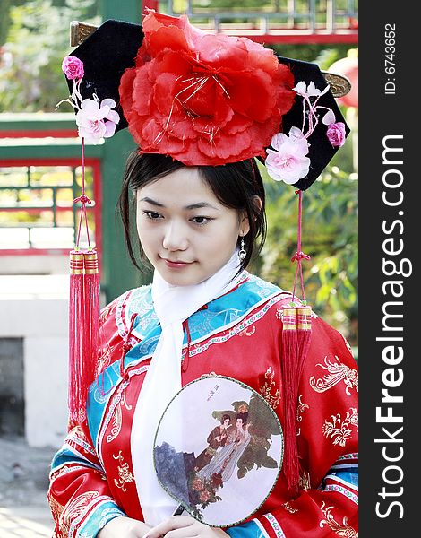 Portrait of a beautiful girl in Chinese ancient dress. 
Chinese on the fan is meant and missed. Portrait of a beautiful girl in Chinese ancient dress. 
Chinese on the fan is meant and missed.