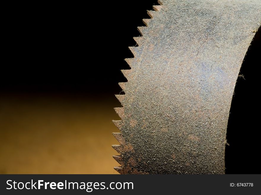 A rusty old curved saw covered in dust. A rusty old curved saw covered in dust