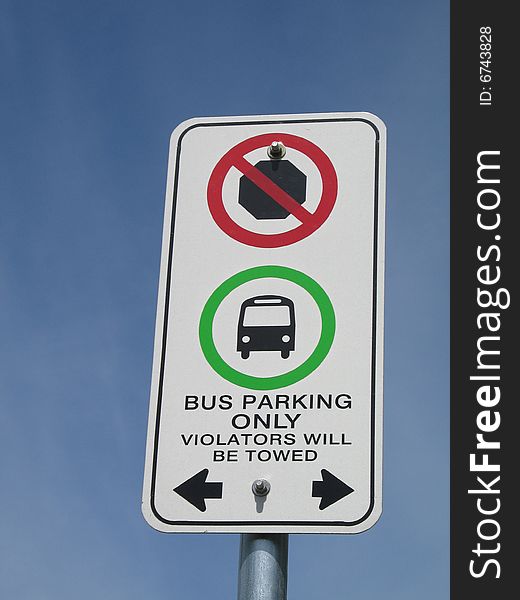 Bus parking sign against blue sky