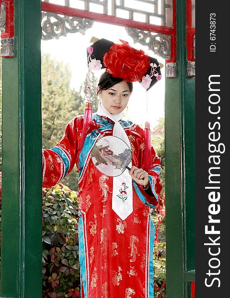 A beautiful girl in Chinese ancient dress is in the royal garden.

This is dress of Qing Dynasty of China. It is the princess' dress too. 

Chinese on the fan is meant and missed. A beautiful girl in Chinese ancient dress is in the royal garden.

This is dress of Qing Dynasty of China. It is the princess' dress too. 

Chinese on the fan is meant and missed.