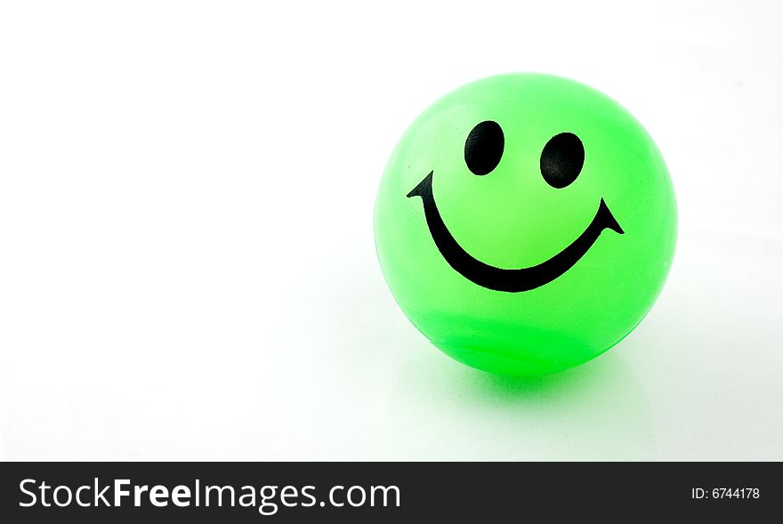 Green smiley ball on white background with copy space