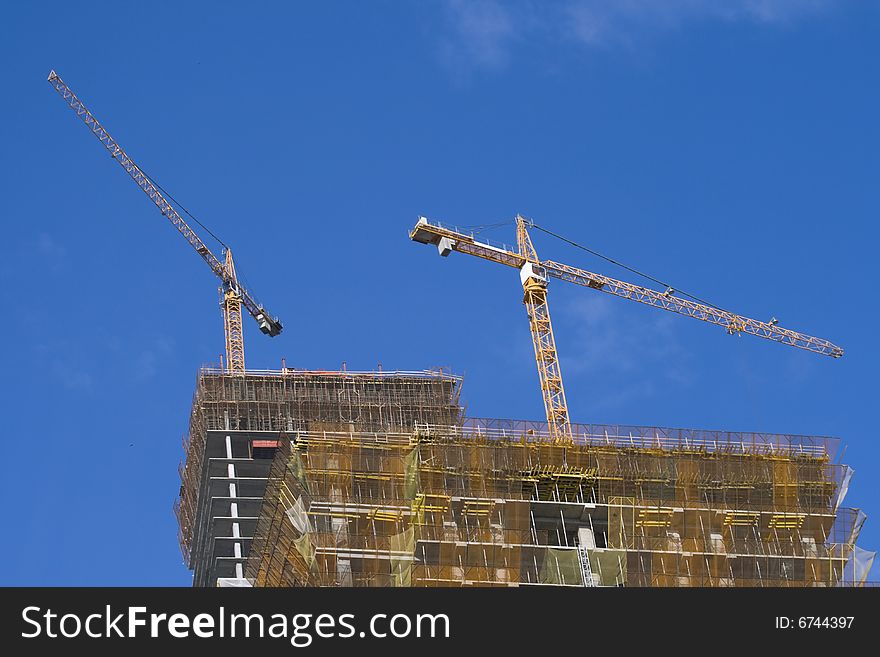 Construction of skyscraper with hoisting crane