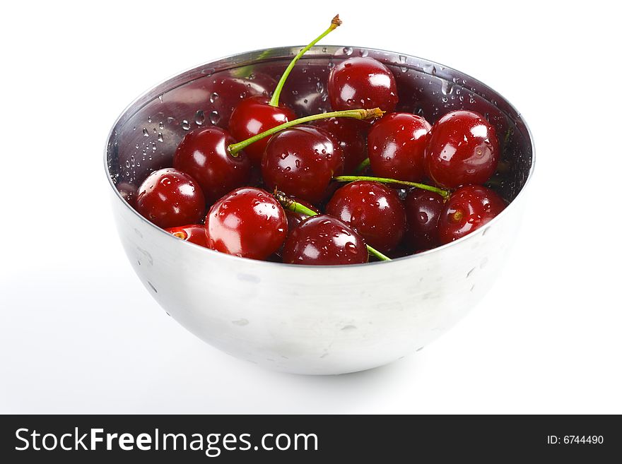 Red cherry in the metal bowl