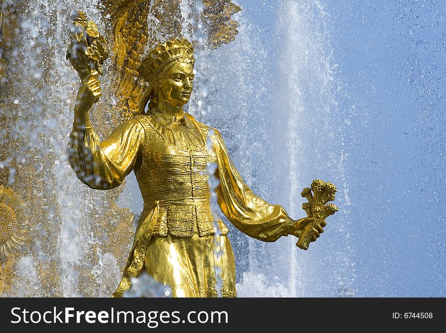 Shining fountain with gold woman's sculpture