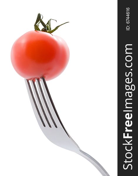 Ripe tomato on fork isolated