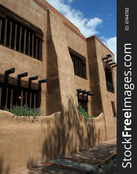 View of building in Santa Fe, New Mexico showing adobe architecture. View of building in Santa Fe, New Mexico showing adobe architecture.