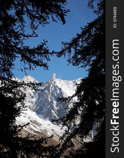 The famous sharp pinnacle of the Dent du Geant, Mont Blanc Massif, Courmayeur, Italy. The famous sharp pinnacle of the Dent du Geant, Mont Blanc Massif, Courmayeur, Italy