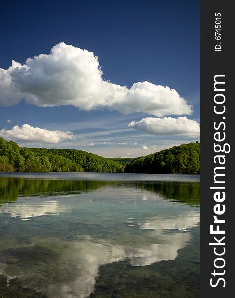 Clear Mountain Lake In Green Forest Of Park