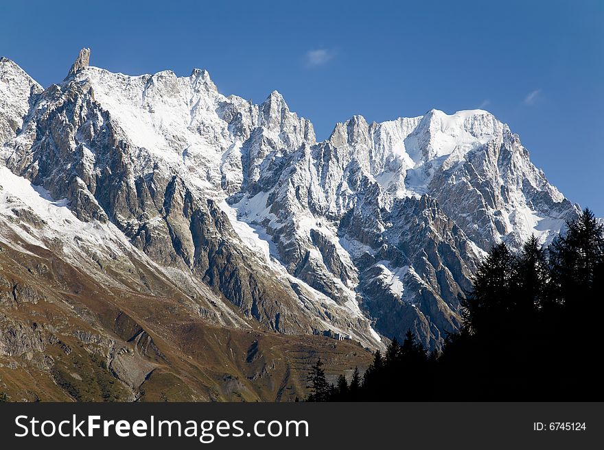 Autumn view of snowcapped peaks in an alpine valley. Gran Jourasses (Mont Blanc massif), Val Veny, Courmayeur, Italy. Autumn view of snowcapped peaks in an alpine valley. Gran Jourasses (Mont Blanc massif), Val Veny, Courmayeur, Italy.