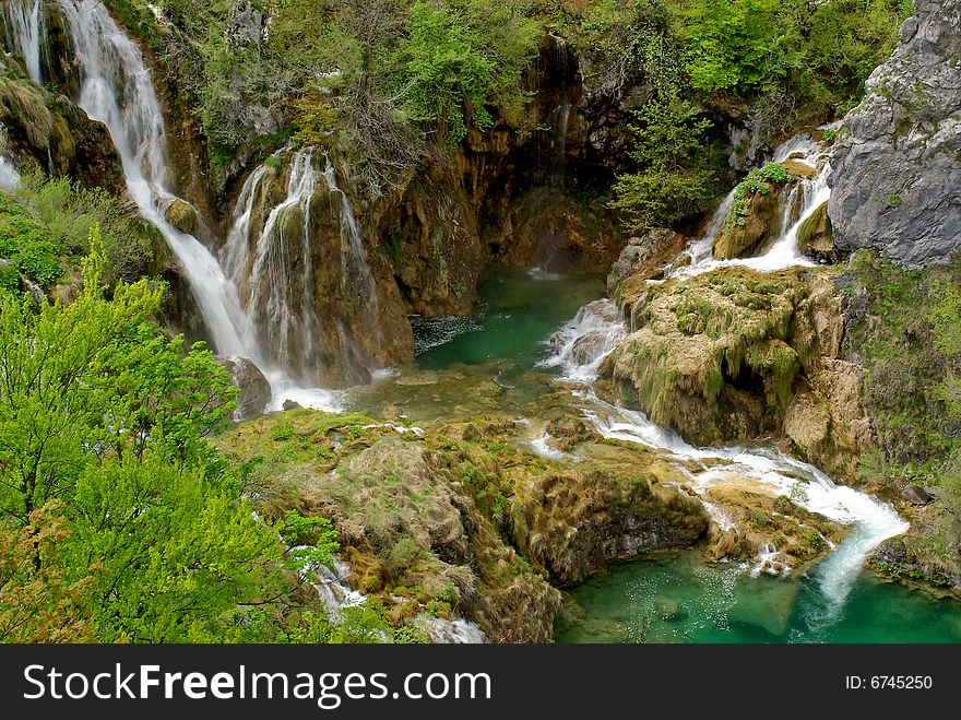 Watefalls With Blue Water In Plitvice Lakes