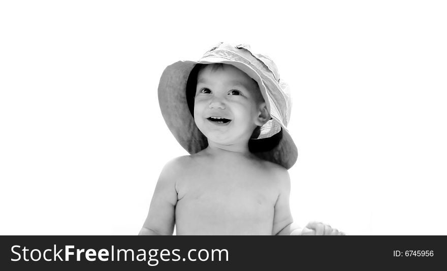 Baby boy in father's hat over white