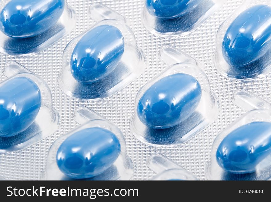 Blue oval medical pills in their packages. Blue oval medical pills in their packages