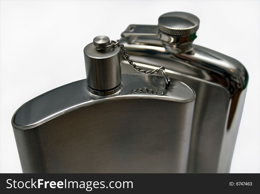 Two metal flasks closeup with a white background