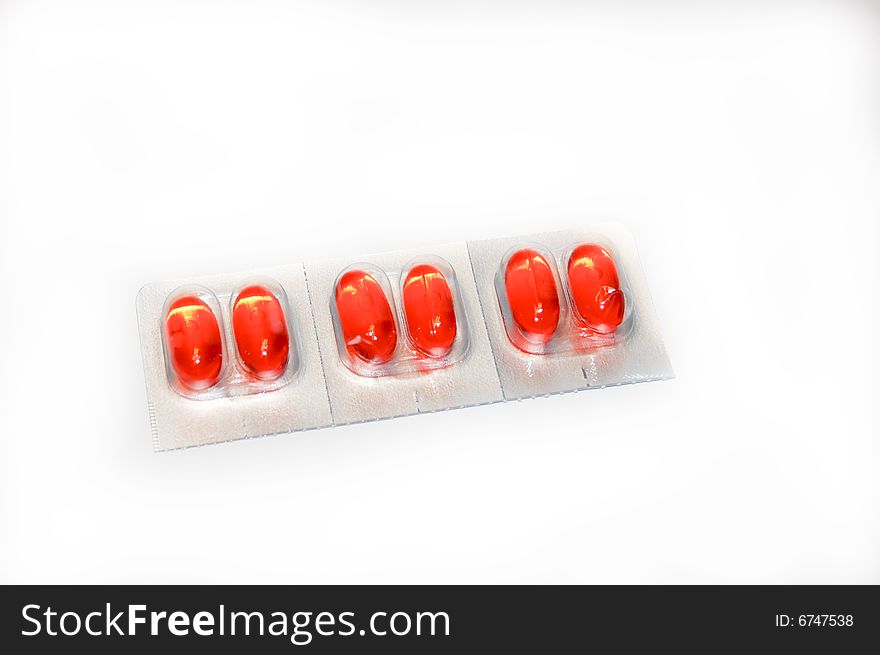 A pack of orange medication pills. A pack of orange medication pills