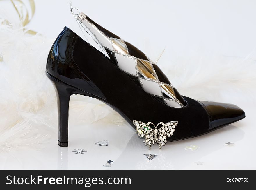 Christmas stilettos with diamante butterfly jewellery and white feathers background. Clipping path included for easy removal. Christmas stilettos with diamante butterfly jewellery and white feathers background. Clipping path included for easy removal.