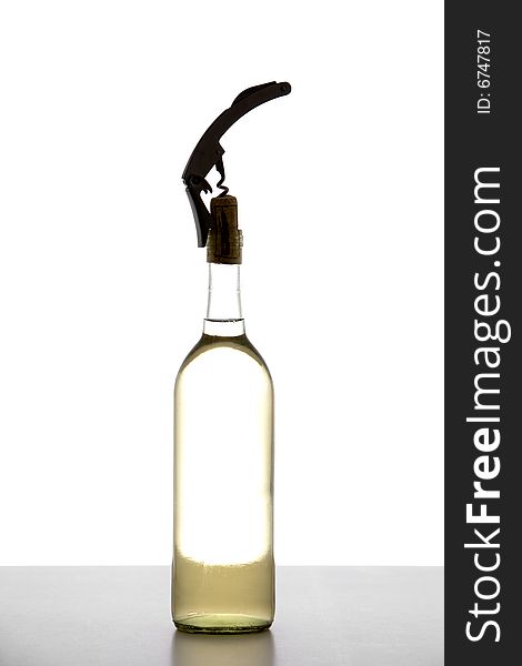 A corkscrew in opening a bottle of wine