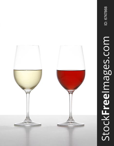 Two wine glasses one red one white in the studio