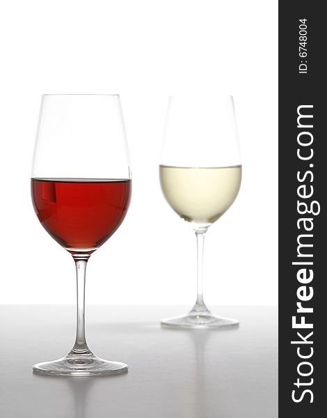 Two wine glasses one red one white in the studio