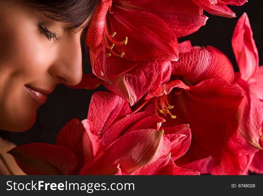 Smiling girl with close eyes and red flowers. Smiling girl with close eyes and red flowers