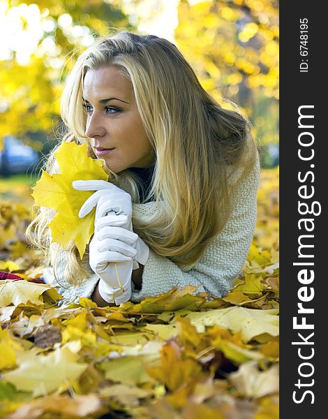 Lady lying on the ground of maple leaves. Lady lying on the ground of maple leaves