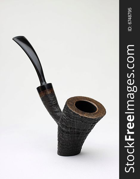 An black tobacco pipe on white background from Denmark.