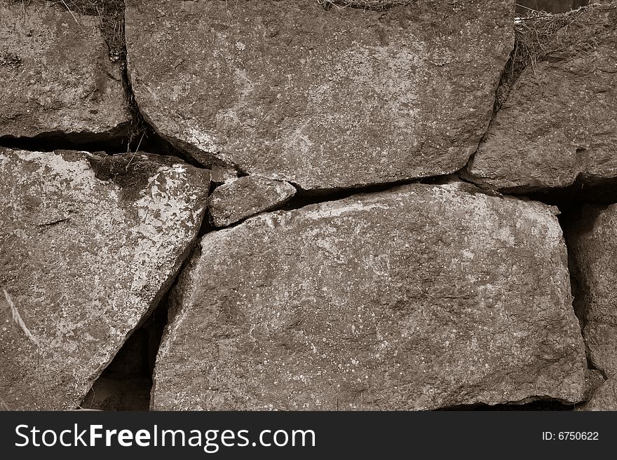 Aged stone wall background sepia toned