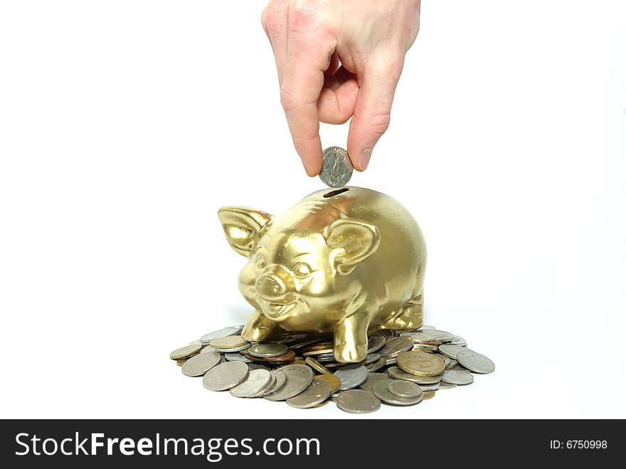 Hand inserting coin into piggy bank isolated on white