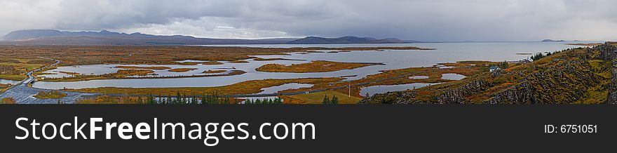 Extra large panoramic view to a lake with islands in Iceland