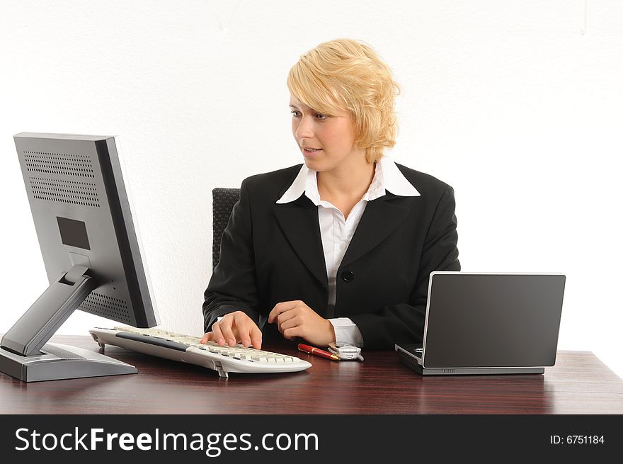 Young business woman working in a modern office.Isolated over white.