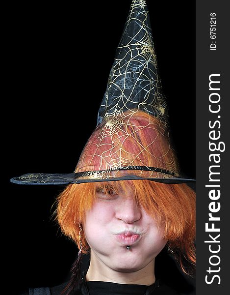 Redhair scarecrow in wizard's hat on black background