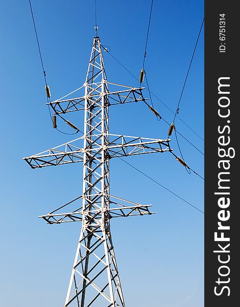 Power lines and electric pylon on a background of sky