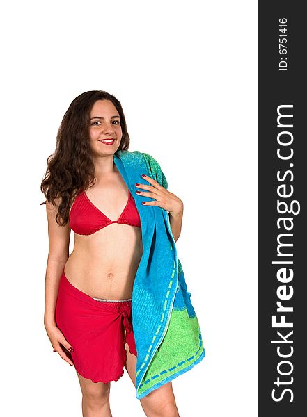 A beautiful girl, wearing red swim suit, holding a beach towel over her shoulder, smiling. A beautiful girl, wearing red swim suit, holding a beach towel over her shoulder, smiling