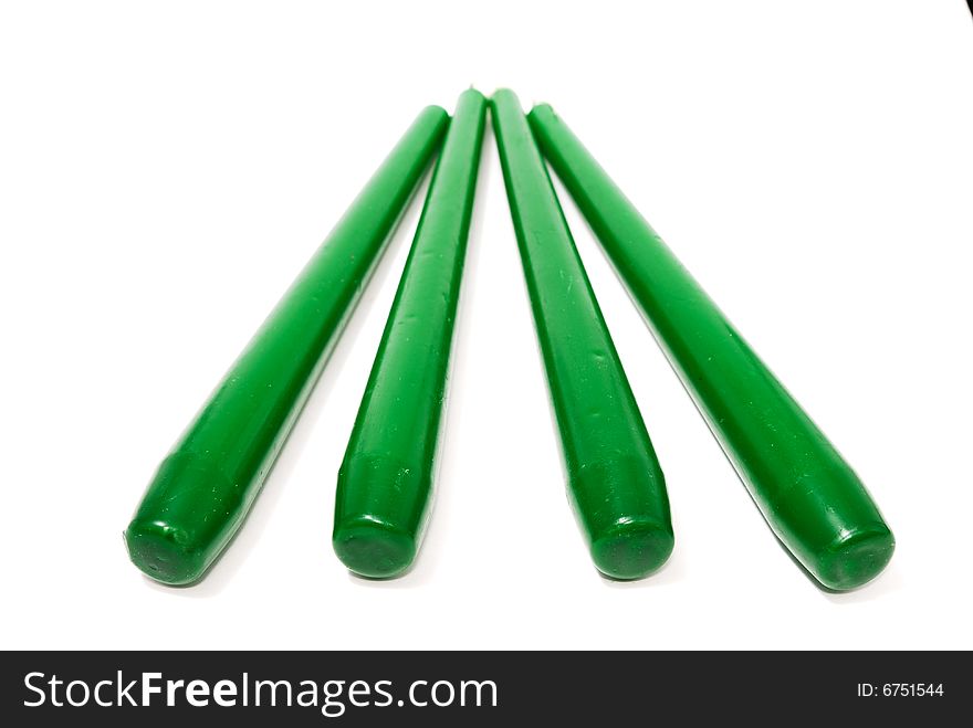 Green candles isolated on white background