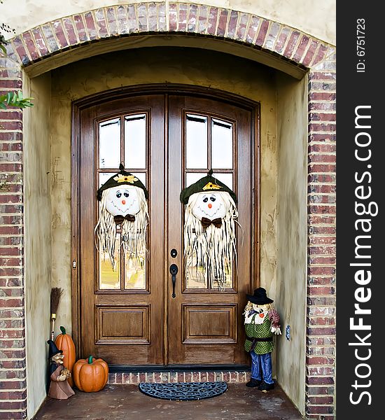 Double Doors decorated with scarecrow faces and other fall decorations. Double Doors decorated with scarecrow faces and other fall decorations.