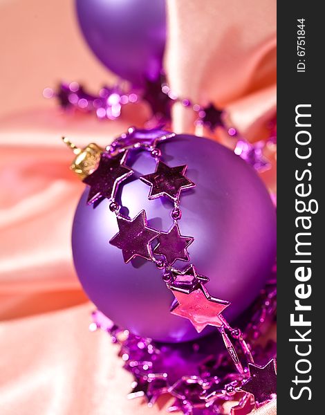 Holiday series: close up of pink christmas bal and star garland. Holiday series: close up of pink christmas bal and star garland