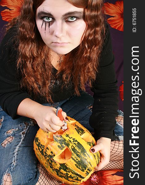 Adorned girl to Halloween c by pumpkin in the hands. Adorned girl to Halloween c by pumpkin in the hands