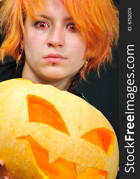 Red-hair witch with pumkin on black background