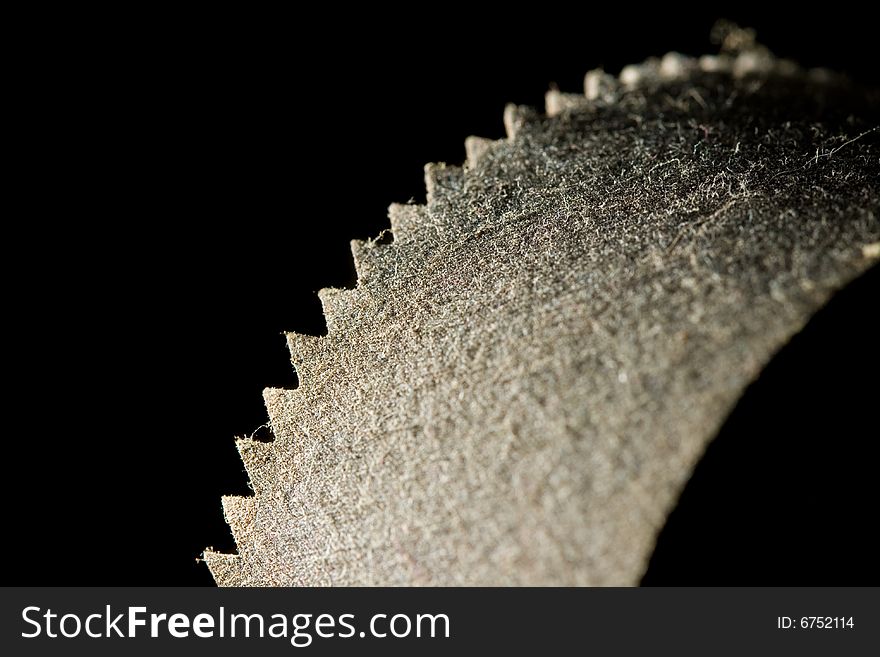 A rusted old saw blade covered in dust. A rusted old saw blade covered in dust