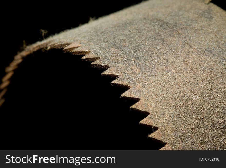 A rusted old saw blade covered in dust. A rusted old saw blade covered in dust