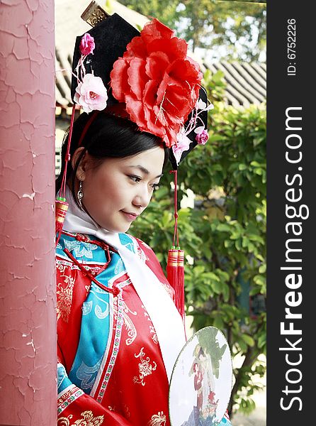 A beautiful girl in Chinese ancient dress is in the royal garden. This is dress of Qing Dynasty of China. It is the princess' dress too. Chinese on the fan is meant and missed. A beautiful girl in Chinese ancient dress is in the royal garden. This is dress of Qing Dynasty of China. It is the princess' dress too. Chinese on the fan is meant and missed.