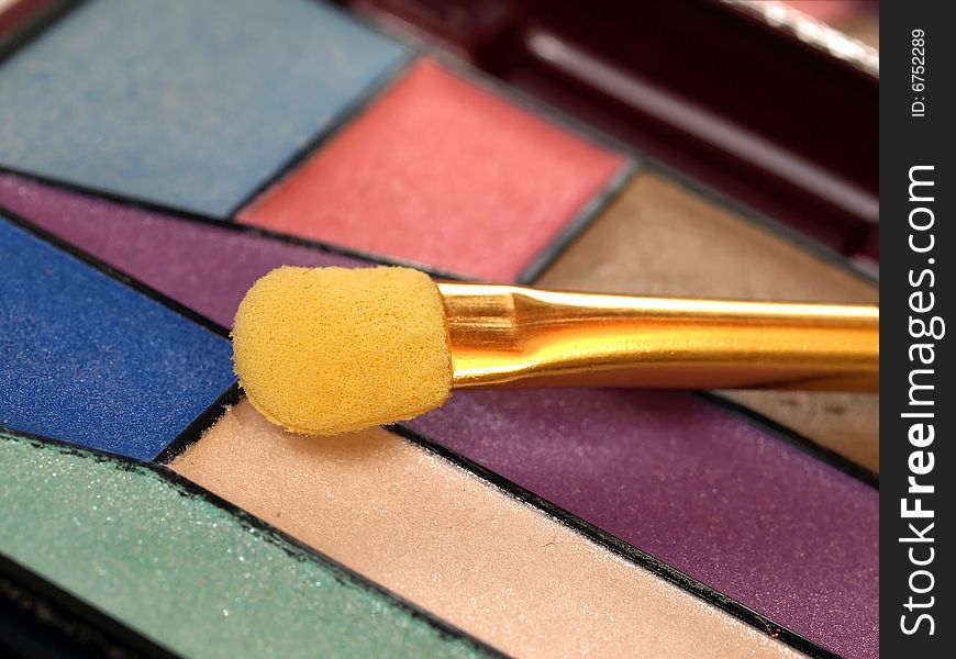 A colorful eyeshadow with applicator. A colorful eyeshadow with applicator