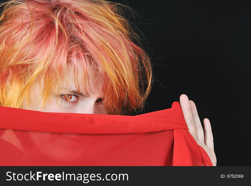 Portrait of the pretty red woman on black background