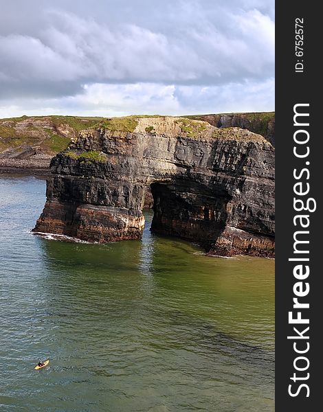 A canoeist at the virgin rock in ballybunion ireland as seen from the cliffs