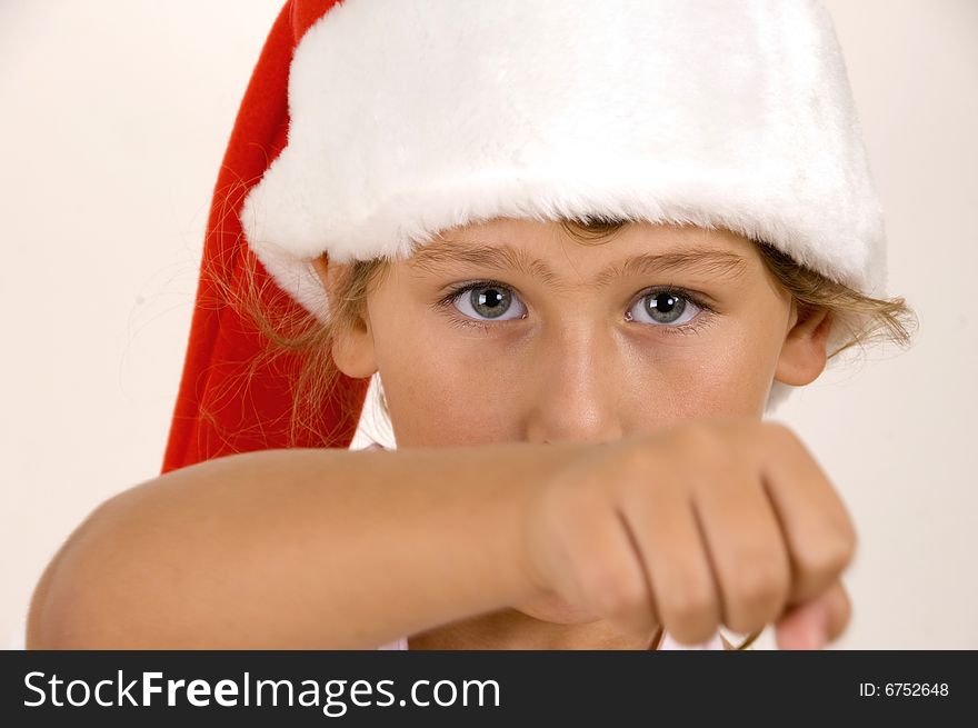 Little girl with christmas hat showing punch