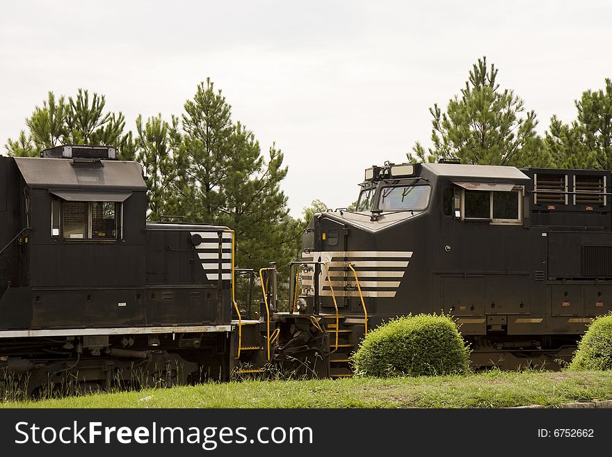 Two black train engines facing each other on track. Two black train engines facing each other on track