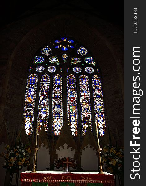 An alter and stained glass window in a church in cork ireland. An alter and stained glass window in a church in cork ireland