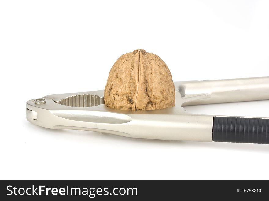 Nutcracker and a walnut isolated on white background