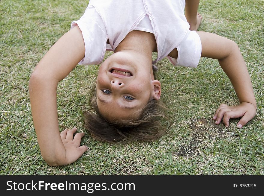 Girl doing cartwheel in the grass